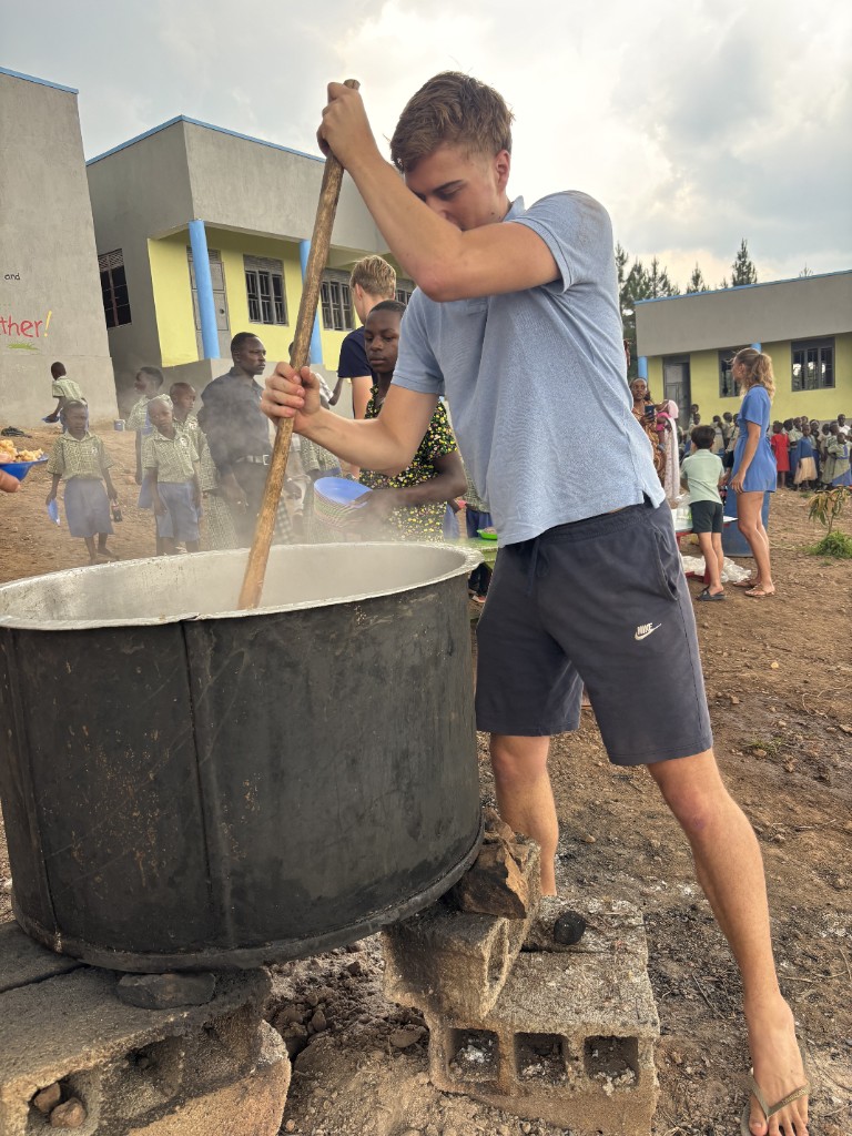 Volunteers preparing community meals for children at a Serah Project school visit in Uganda