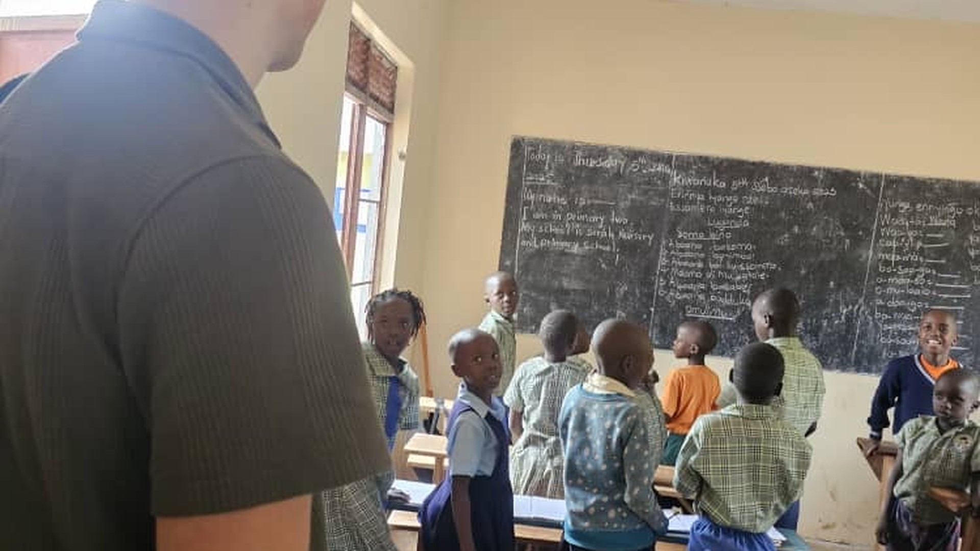 Serah Foundation volunteer with children at Serah Nursery and Primary School — funded by every Mwanzo booking