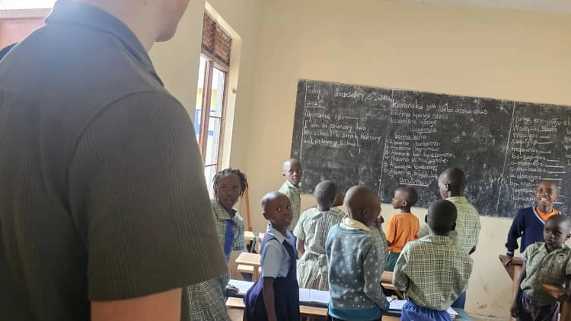 Serah Foundation volunteer with pupils at Serah Nursery and Primary School